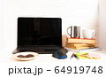 Home office concept. Work from home. Black laptop, books and cafe cuo on the white wooden background. Side view.  64919748