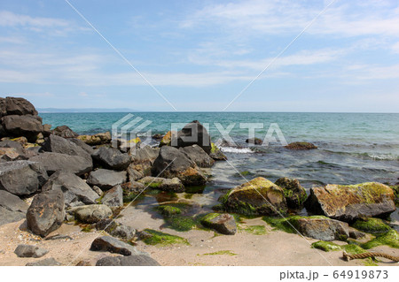Beach and sea in bright sunlight Beach and sea in bright sunlight 64919873