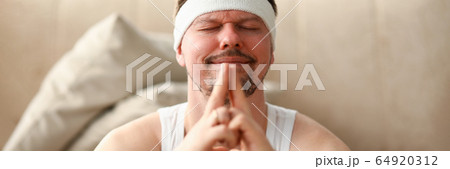 Man during self-isolation after sports meditates Man during self-isolation after sports meditates 64920312