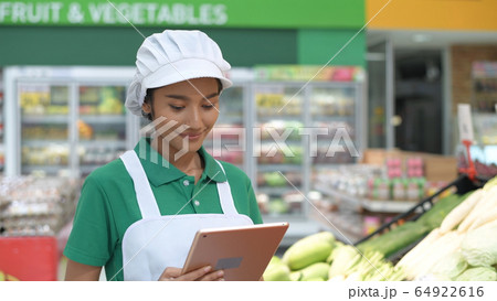 Shopping concepts. Woman using tablet to inspect 64922616