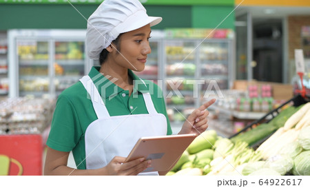Shopping concepts. Woman using tablet to inspect 64922617