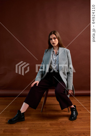 Independent young woman posing in the photostudio. Independent young woman posing in the photostudio. 64924110