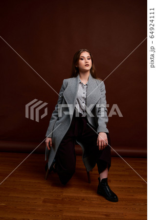 Independent young woman posing in the photostudio. 64924111