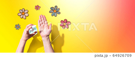 Applying sanitizer for cleaning hands with flower drawings Applying sanitizer for cleaning hands with flower drawings 64926709