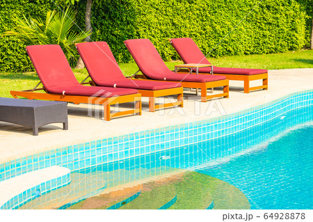 Beautiful empty chair around outdoor swimming pool in hotel resort 64928878