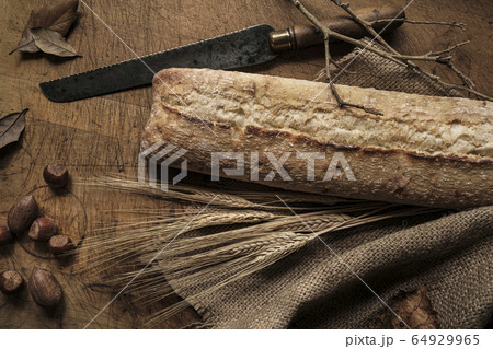 Bread, knife, wheat, acorns, branches, leaves and fabric 64929965
