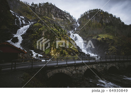 Road by Latefossen waterfall in Vestland, Norway 64930849