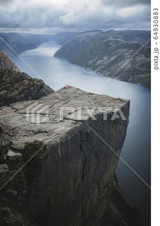 Tent in distance on Preikestolen cliff in Rogaland, Norway Tent in distance on Preikestolen cliff in Rogaland, Norway 64930883