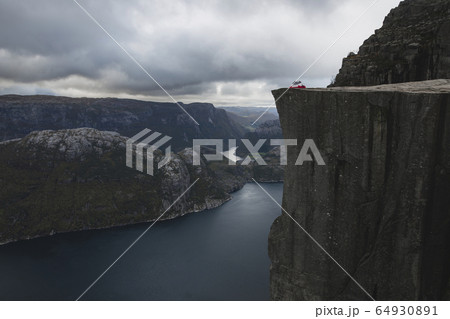 Tent in distance on Preikestolen cliff in Rogaland, Norway Tent in distance on Preikestolen cliff in Rogaland, Norway 64930891