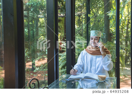 Arab muslim businessman use smartphone Arab muslim businessman use smartphone 64935208