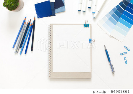 Classic Blue. Color of the Year 2020. Top view of workspace with white notebook, color palette, fabric sample and copy space. Flatlay minimalism. Classic Blue. Color of the Year 2020. Top view of workspace with white notebook, color palette, fabric sample and copy space. Flatlay minimalism. 64935361