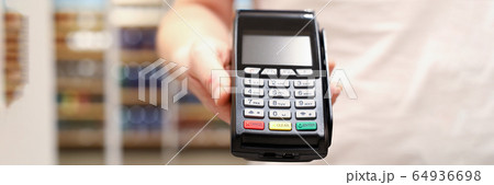 Male businessman hand hold POS terminal closeup Male businessman hand hold POS terminal closeup 64936698