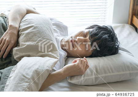 若い男性の寝顔の写真素材