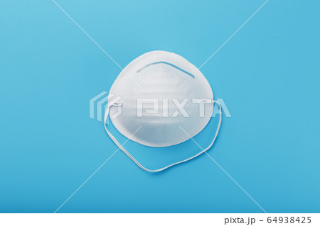Round face mask on a blue background. Virus 64938425