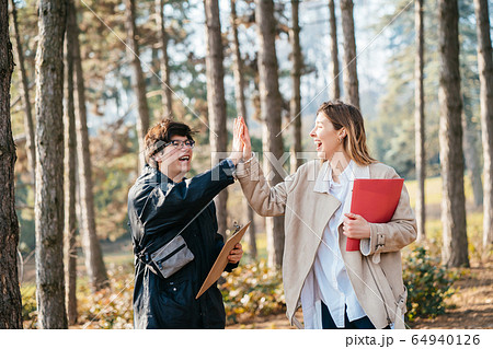 Man give high five woman in the forest Man give high five woman in the forest 64940126