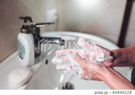 Man washing hands to protect against the coronavirus Man washing hands to protect against the coronavirus 64940228