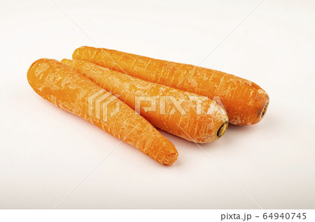 a few ripe carrots on a white background. Close 64940745