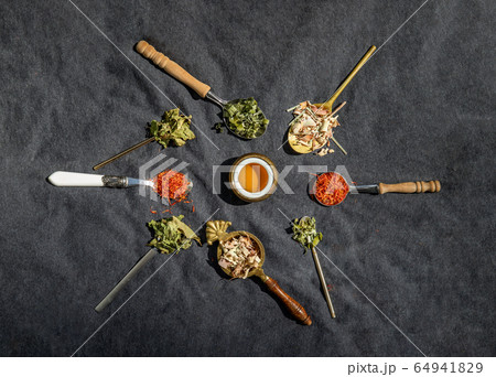 Various teas and dried herbs assortment on spoons Various teas and dried herbs assortment on spoons 64941829
