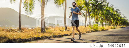 Runner wearing medical mask, Coronavirus pandemic Covid-19. Sport, Active life in quarantine Runner wearing medical mask, Coronavirus pandemic Covid-19. Sport, Active life in quarantine 64942055