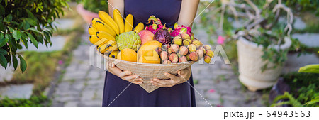 Variety of fruits in a Vietnamese hat. Woman in a Vietnamese hat BANNER, LONG FORMAT Variety of fruits in a Vietnamese hat. Woman in a Vietnamese hat BANNER, LONG FORMAT 64943563