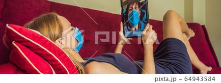 Coronavirus. Woman and man in quarantine for coronavirus wearing protective mask. Working from home Coronavirus. Woman and man in quarantine for coronavirus wearing protective mask. Working from home 64943584