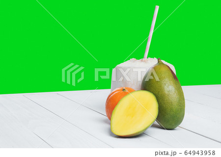 Drinks coconut with straw, mango and mandarin. Drinks coconut with straw, mango and mandarin. 64943958
