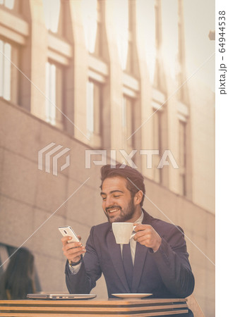 happy manager has online call on phone in cafe for mobile device design. Coffee shop concept. Business technology. Smartphone lifestyle 64944538