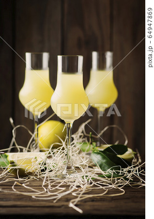 Iralian traditional liqueur with lemons on the 64947869