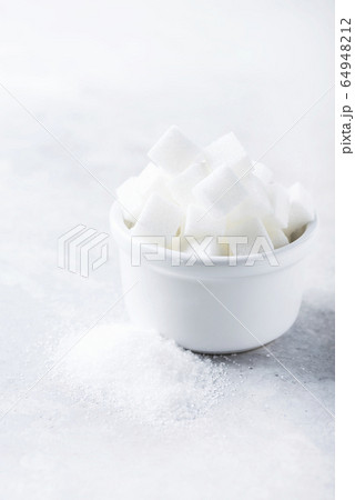 Sugar cubes and grain of sugar Sugar cubes and grain of sugar 64948212