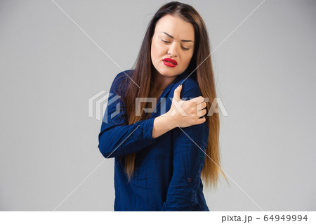 Young woman suffers from pain, feels sick, ill and weakness isolted on studio background 64949994