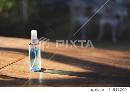 Close-up of 70% Blue Ethyl alcohol spray bottle on the wooden desk. Use for Coronavirus Protection Close-up of 70% Blue Ethyl alcohol spray bottle on the wooden desk. Use for Coronavirus Protection 64951209