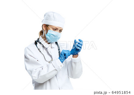 Female young doctor with stethoscope and face mask isolated on white studio background 64951854