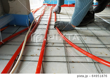The master laid pipes on the floor for heating and The master laid pipes on the floor for heating and 64951876