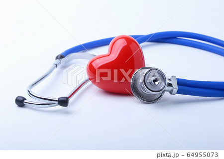 Medical stethoscope and red heart isolated on white. 64955073