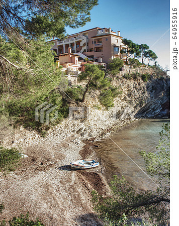 Rocky point with private villas above calm  azure 64955916