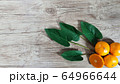 tangerines and leaves on the wooden background 64966644