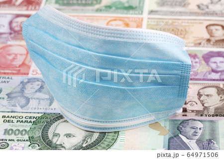 Protective mask on a Paraguayan money 64971506