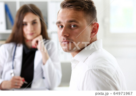 Satisfied happy handsome smiling male patient with doctor 64971967