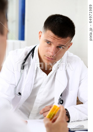 Male doctor hold in arms jar of pills Male doctor hold in arms jar of pills 64971989
