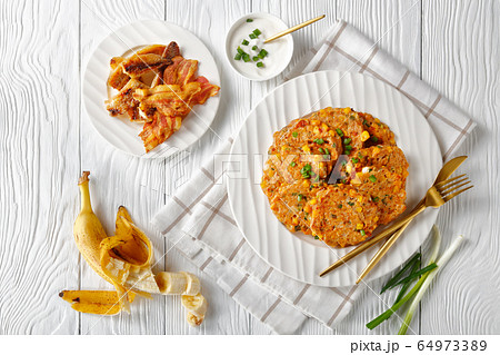 cheese and corn pancakes on a plate, top view cheese and corn pancakes on a plate, top view 64973389