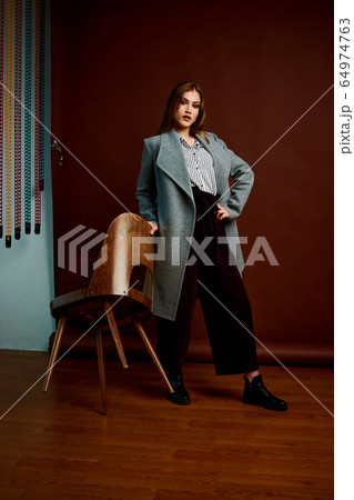 Gorgeous young female in classic suit, black shoes 64974763