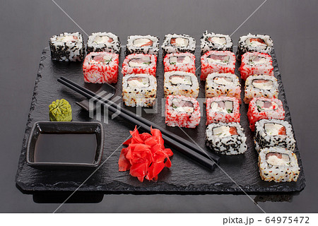 Japanese restaurant, sushi roll on black slate. Japanese restaurant, sushi roll on black slate. 64975472