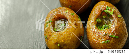 Mini jacket potatoes with a fragrant garlic butter Mini jacket potatoes with a fragrant garlic butter 64976335