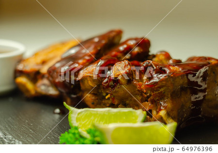 Pork ribs in a smoky flavour barbecue seasoning 64976396