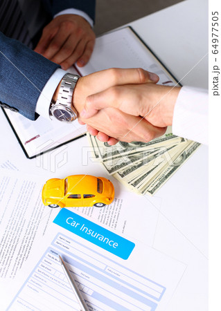 Insurance form lying on table with yellow toy car Insurance form lying on table with yellow toy car 64977505