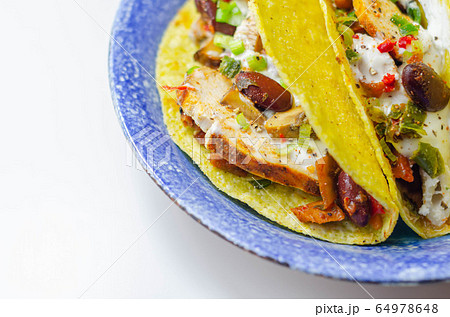 Mexican tacos shells with chicken and red kidney 64978648