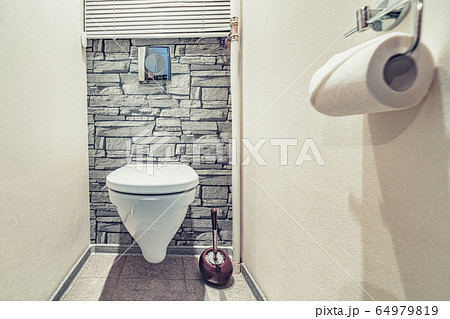 White built in toilet bowl in modern bathroom with paper holder and toilet brush White built in toilet bowl in modern bathroom with paper holder and toilet brush 64979819