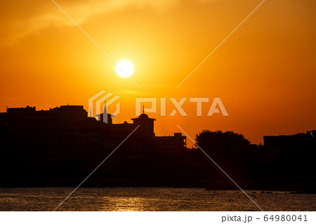 Golden sunset on the beach. Silhouette of the 64980041