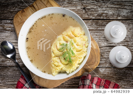 Pure white borscht served with mashed potatoes. Pure white borscht served with mashed potatoes. 64982939