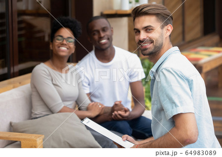 Professional male psychologist holding clipboard consulting young couple portrait 64983089